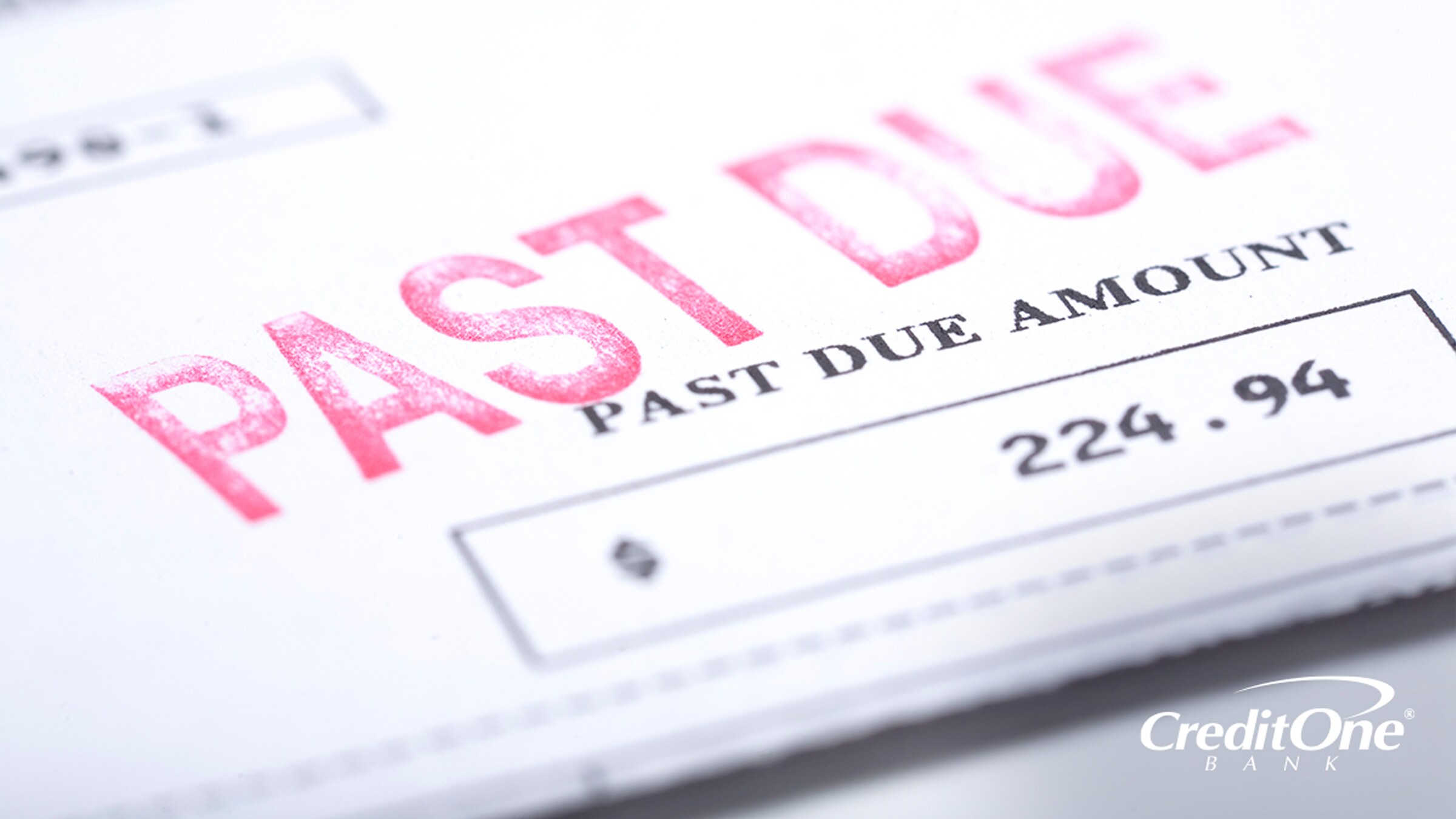 A past-due bill notice sits on a table, perhaps raising concerns about how long late payments stay on your credit report.