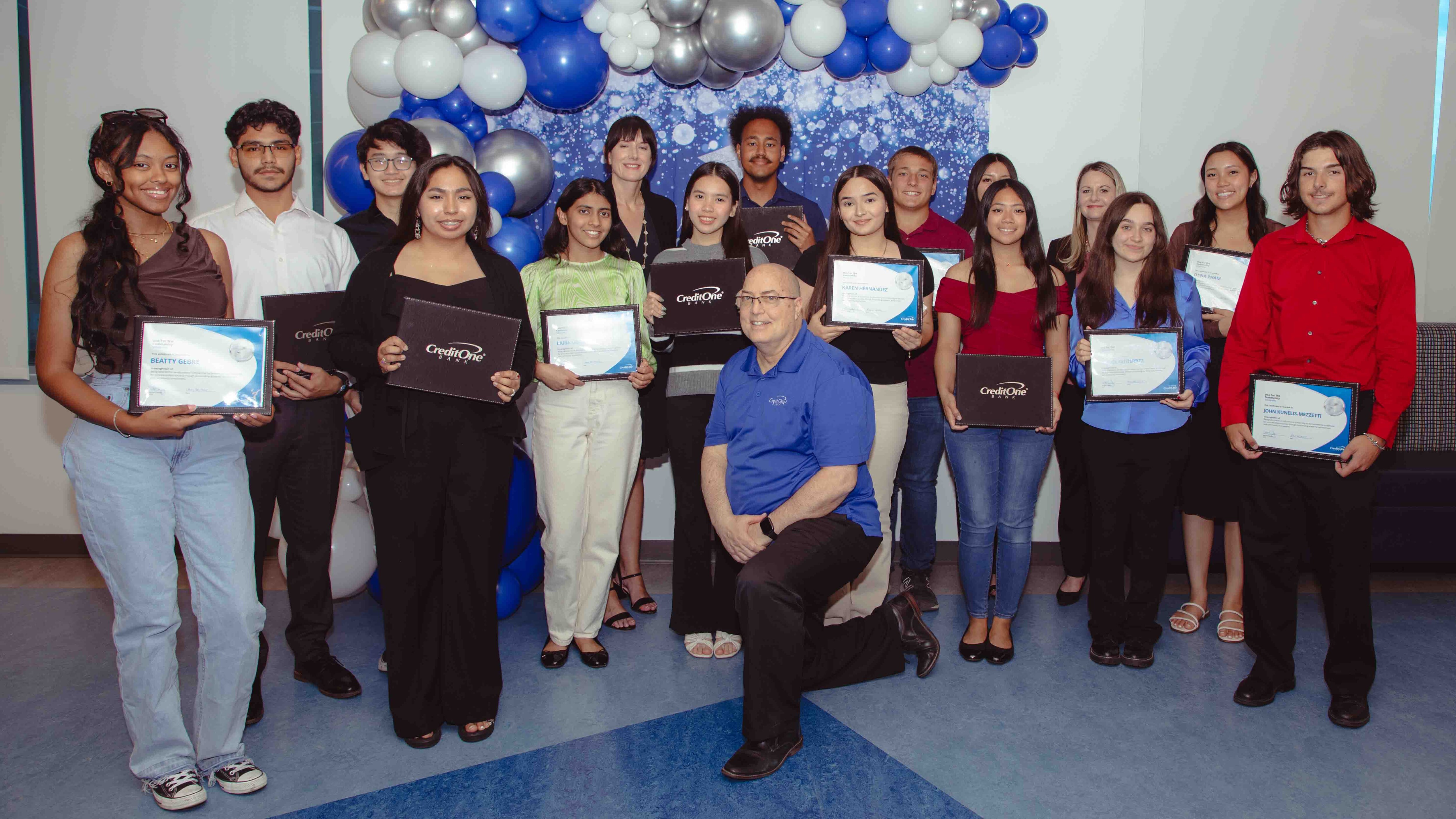 Credit Bank Senior Vice President, Corporate Functions Lenny Chide poses with the the 2024 One For The Community Scholarship Recipients