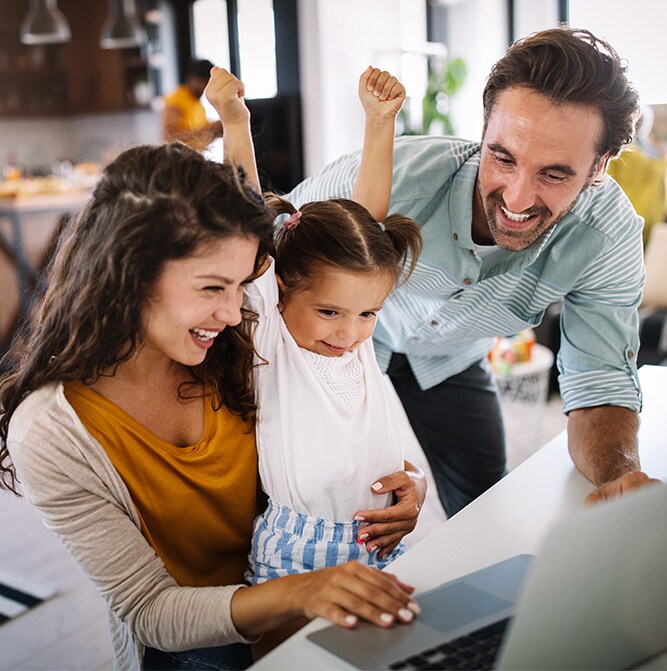 Man, woman, and child in front of a laptop